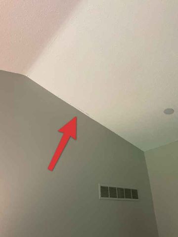 Hairline crack at ceiling line