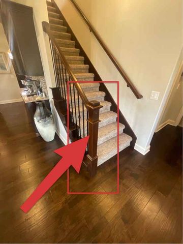 Loose handrail at base of stairs
